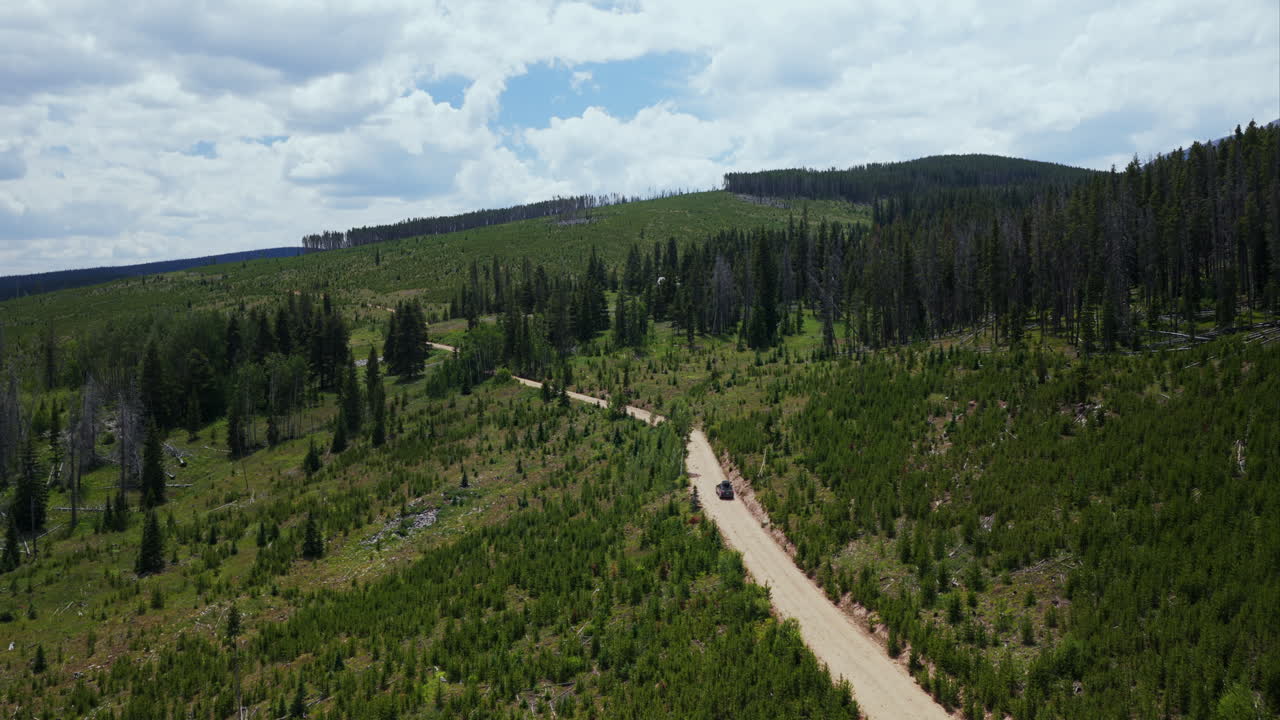 Mount of the Holy Cross AWD car driving dirt road car aerial drone Rocky Mountains Colorado Notch Mountain creek Falls Creek Trail Half moon pass Vail Minturn summer morning blue sky forward follow