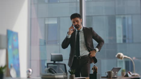 elegant business man calling partners standing luxury office sunny morning.