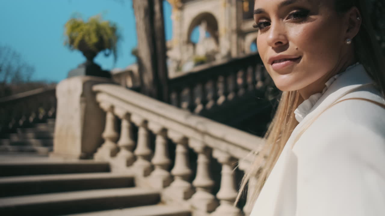 스타일리시한 젊은 여성이 야외에서 공원을 고 있습니다.