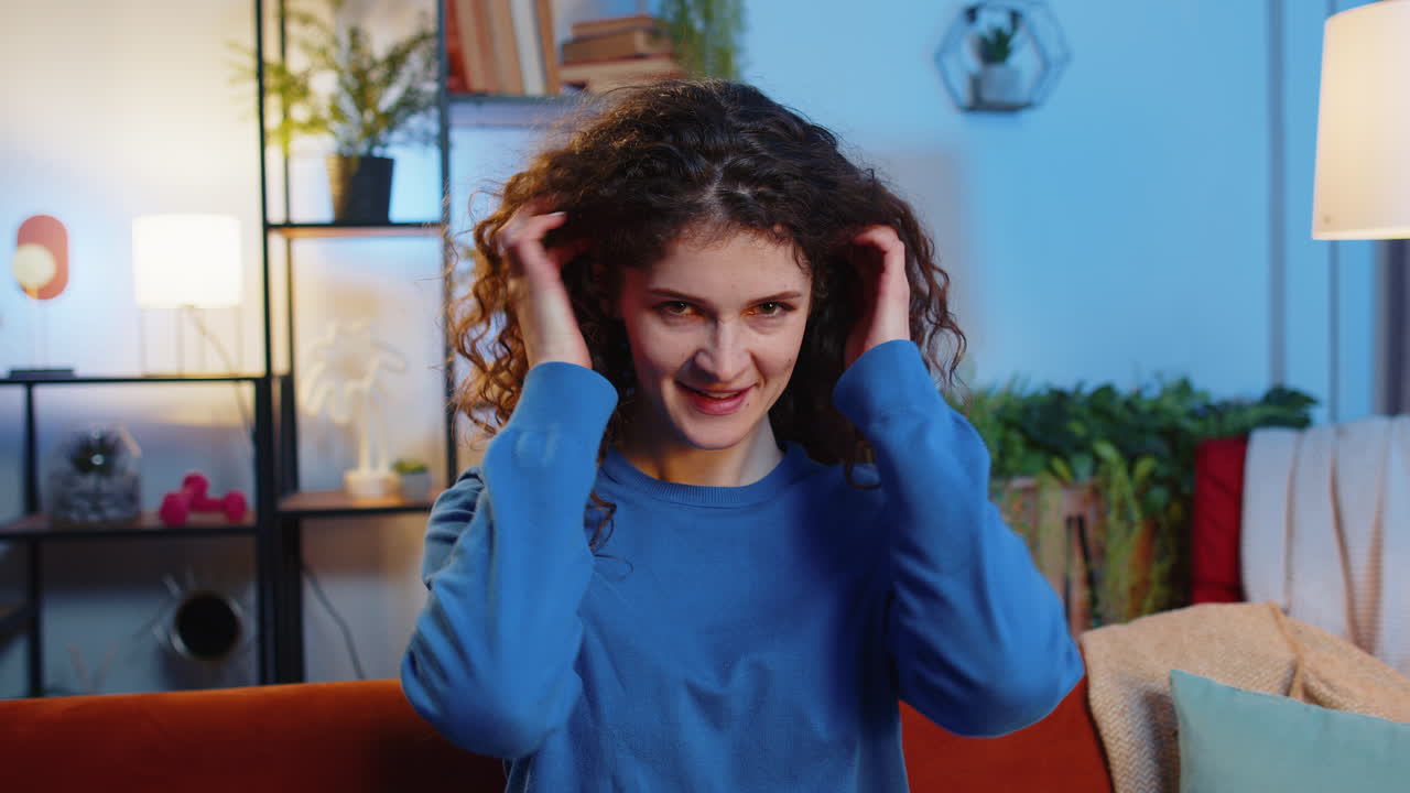 Portrait of cheerful young woman smiling beautiful female playing adjusting her wavy hairstyle