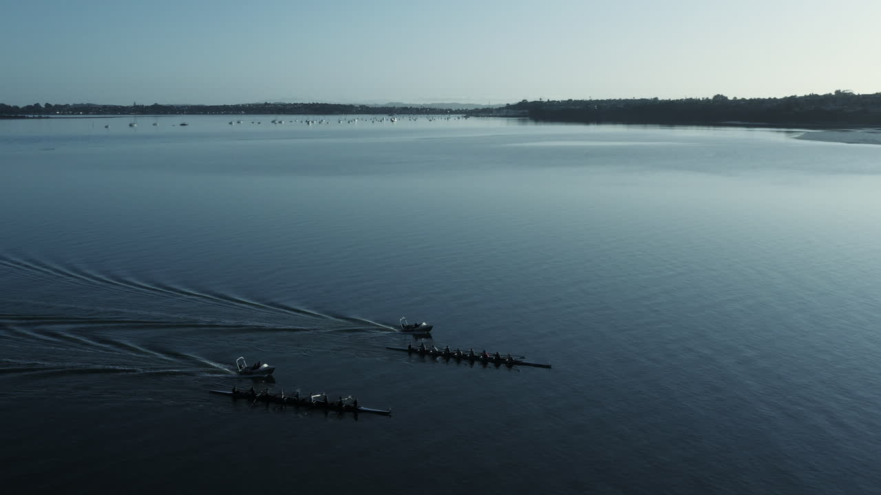 Sideways aerial shot of competition of two quadruple sculls, Auckland