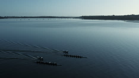 Sideways-aerial-shot-of-competition-of-two-quadruple-sculls,-Auckland