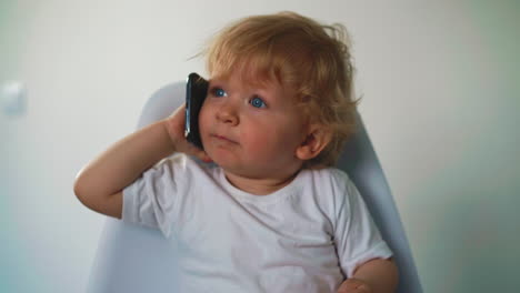 cute child with blue eyes holds in his hand