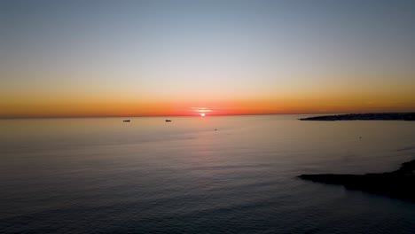 vista aérea de lapso de tiempo volando sobre el océano hacia la espectacular puesta de sol cerca de la bahía de cascais
