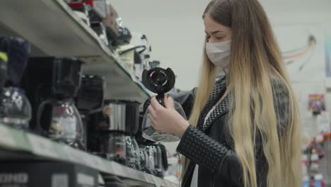 woman shopping for coffee makers in a store