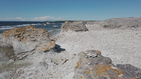 rauk field landscape by sea on sunny day in gotland, sweden, rising