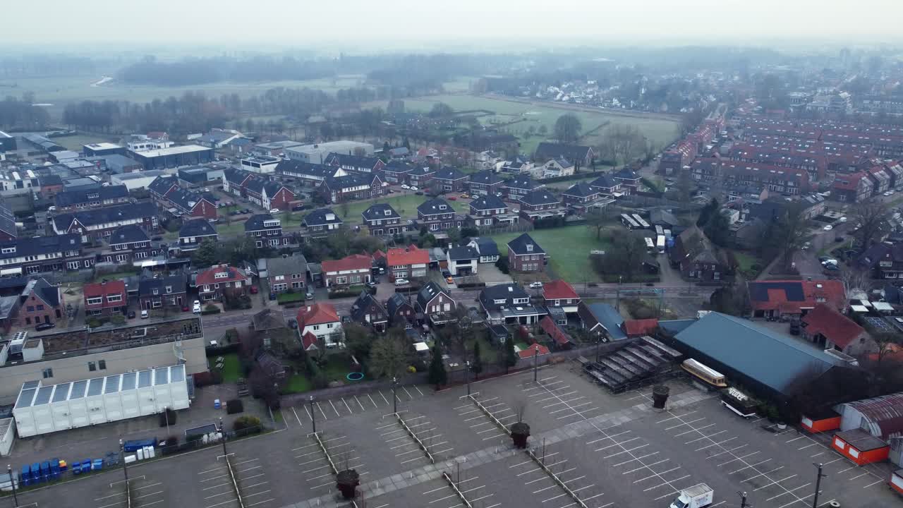 Aerial view of a cityscape with houses and a parking lot