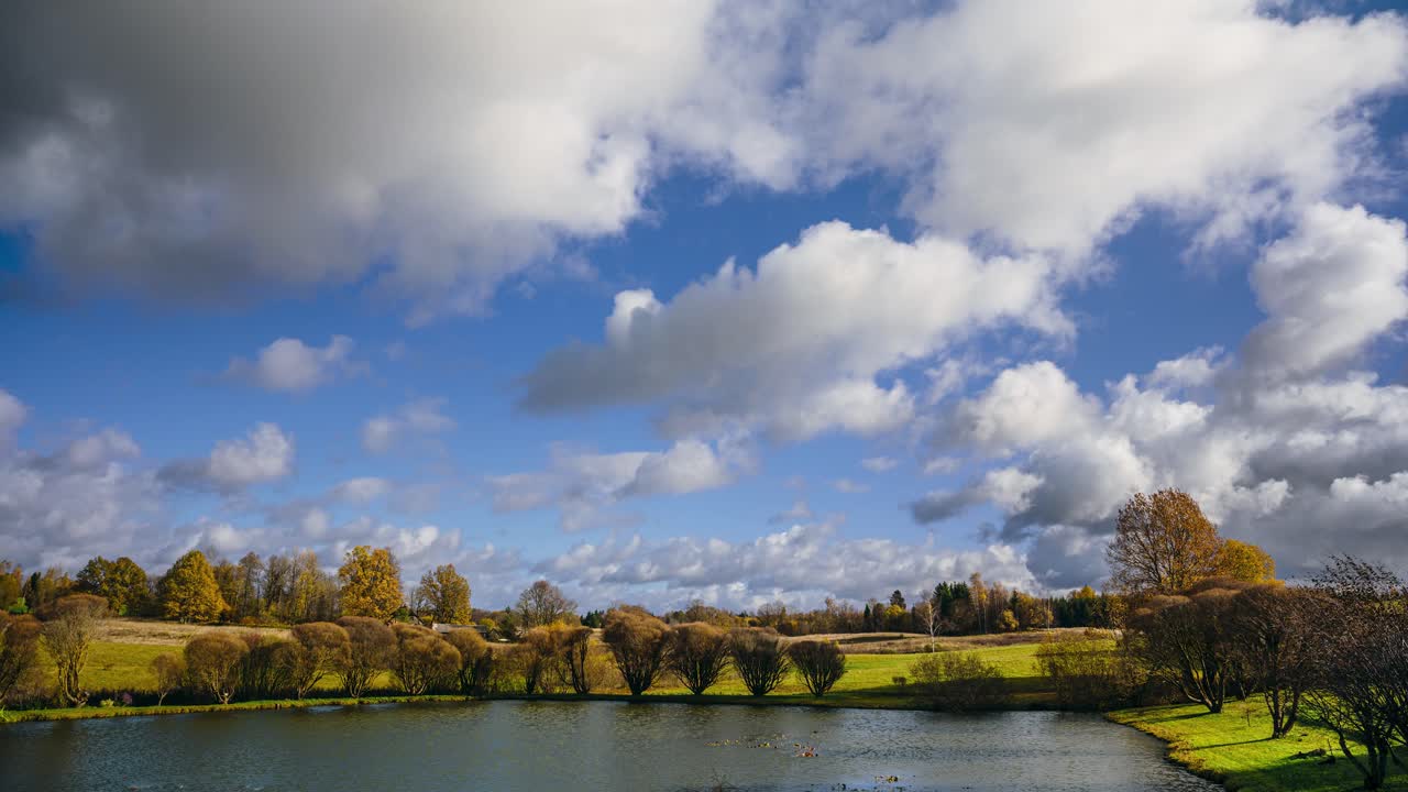 Countryside timelapse with clouds rolling in. Autumn season in rural landscape.