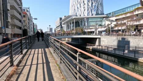 a person walking down a city riverwalk