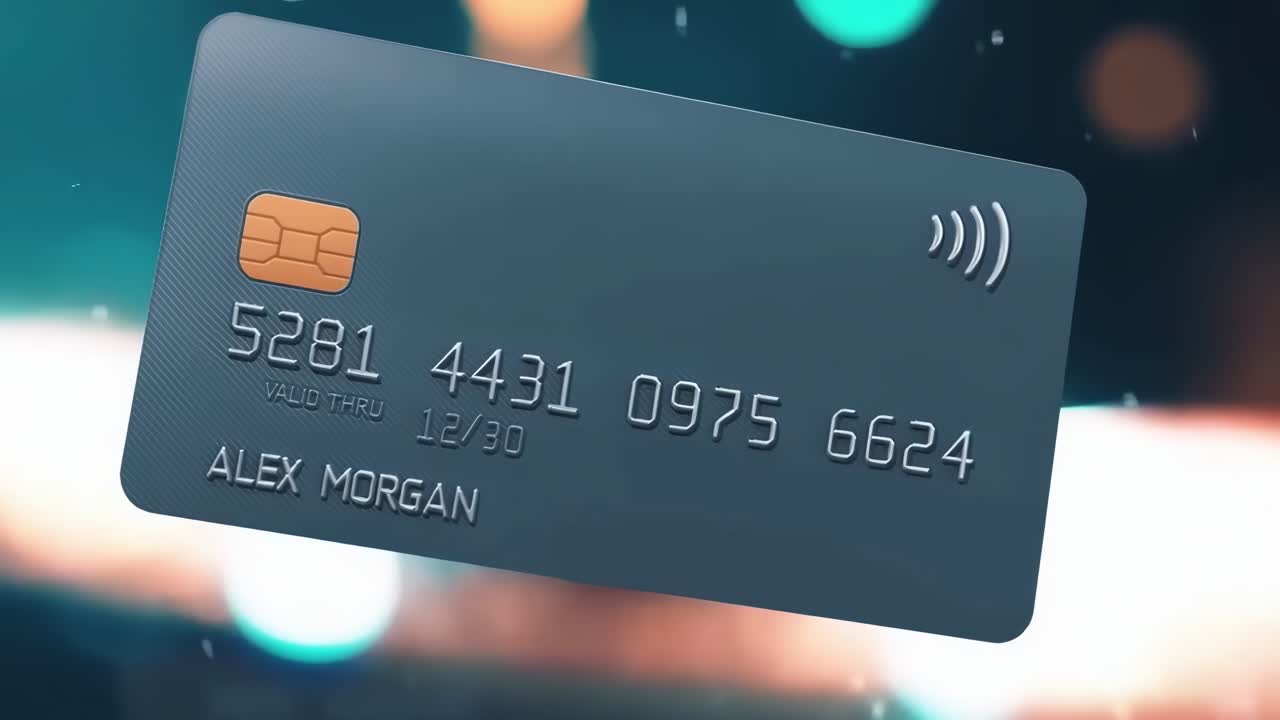Detailní video kreditní karty s bokeh efektem světel, natočené mírně shora.