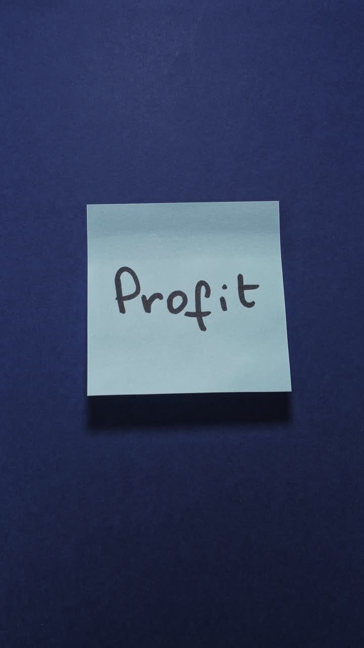Hands posting Profit sticky note on dark blue wall, illustrating earnings