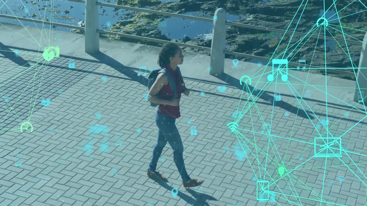 Animation of network of connections with technological icons over woman walking on park