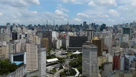 Aerial-view-of-colorful-buildings-in-sunny-Sao-Paulo,-Brazil---reverse,-drone-shot