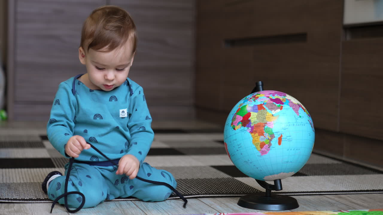 Baby Exploring a Globe