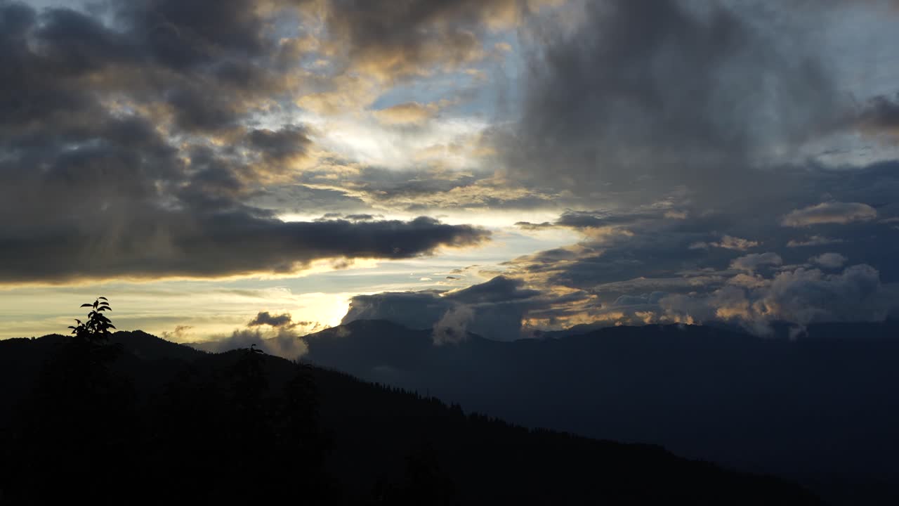 Sunset between mountains and clouds