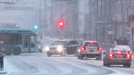 gomel, belarus. city traffic on sovetskaya street in winter snowy snowstorm evening time