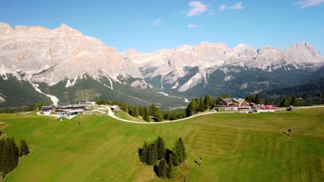 recreation centre on top of hill, background of high mountain peaks