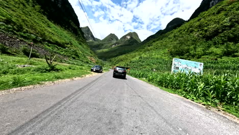 a vehicle on the epic road of the ha giang loop in northern vietnam. tracking shot