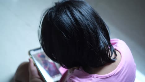 child looking at mobile phone