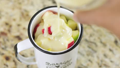 condensed milk getting added to the fruit cocktail