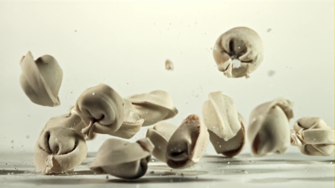 Frozen Dumplings Falling and Scattering on a White Background in Slow Motion