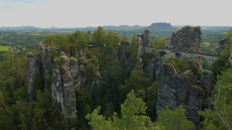 bastei elbsandsteingebirge sachsen elbe sandstone formations rising above dense green forests mountains, showcasing the region’s natural beauty and rugged terrain