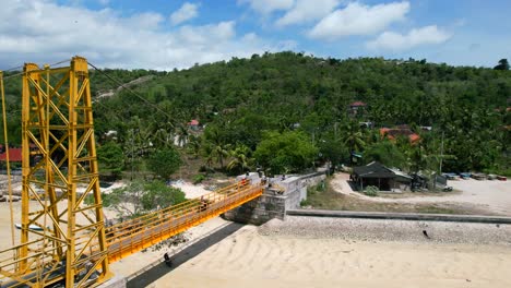 Antenne-Der-Berühmten-Gelben-Brücke-Auf-Der-Insel-Nusa-Lembongan-In-Bali-Indonesien-Mit-Gestrandeten-Booten,-Die-Bei-Ebbe-Verankert-Sind