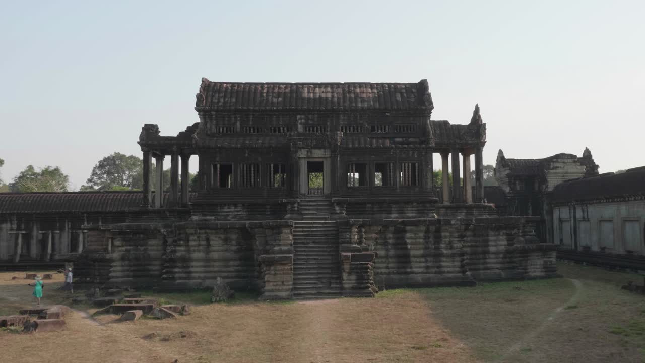 Forward Dolly Through A Doorway Revealing A Building At The Courtyard Of Angkor Wat. 4K.