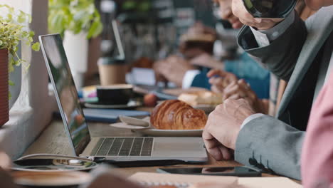 diverse business people hands using laptop computers in busy cafe bustling with activity working online browsing sharing digital email communication