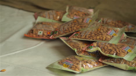 women work in a factory in afghanistan producing and packaging dried almonds