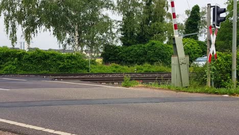 static view of train barriers opening, with train rails and light in view