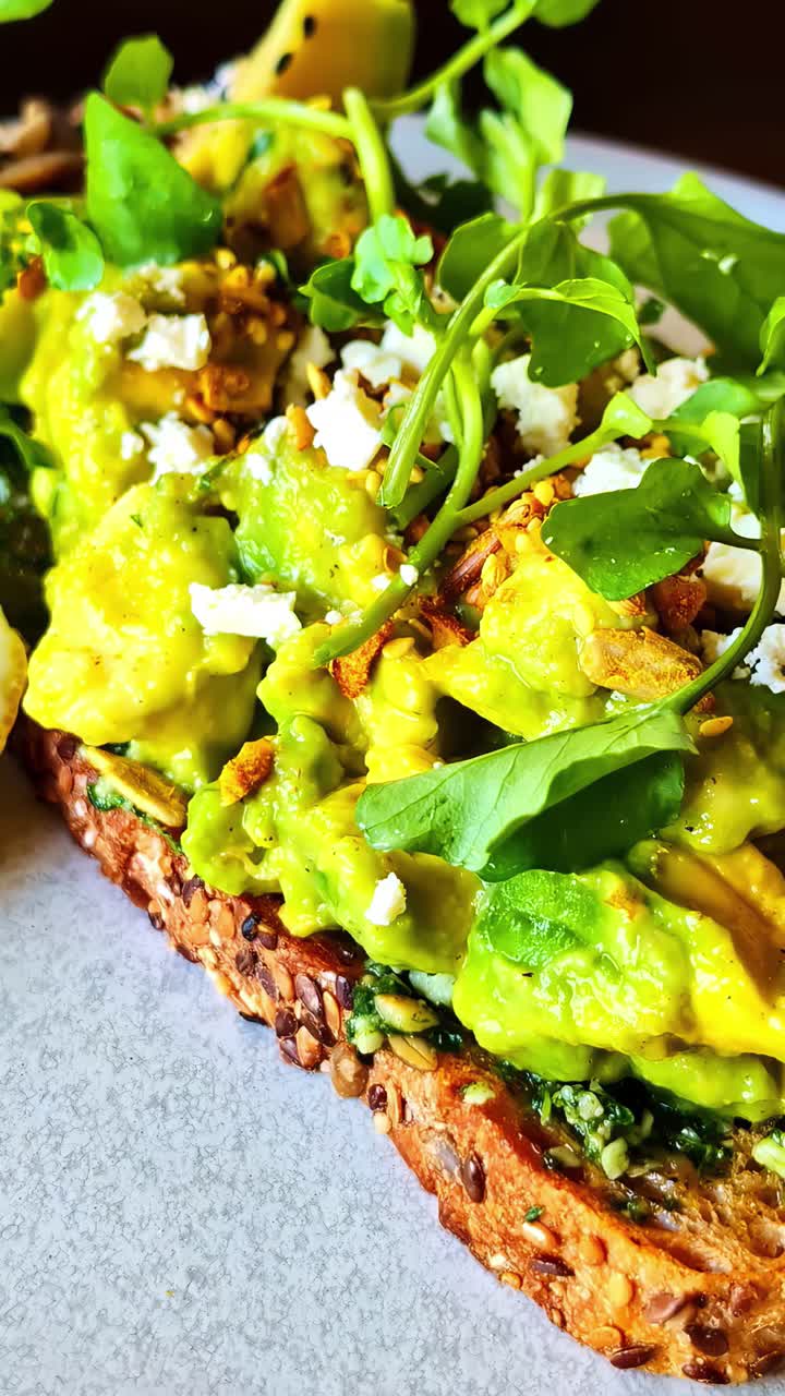 Wheat toast with avocado, cottage cheese, and sprouts. Vertical close-up