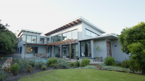 modern house with large windows and lush garden in residential neighborhood, copy space