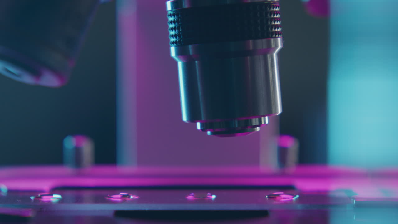 Close Up Microscope Objective Lens Turning over Glass Slide with Specimen