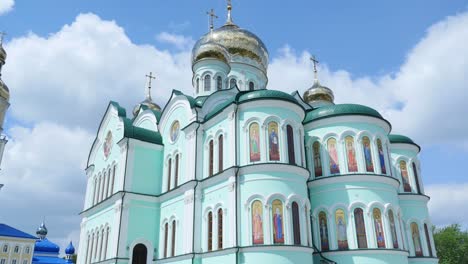 eastern orthodox crosses on gold domes cupolas against blue cloudy sky
