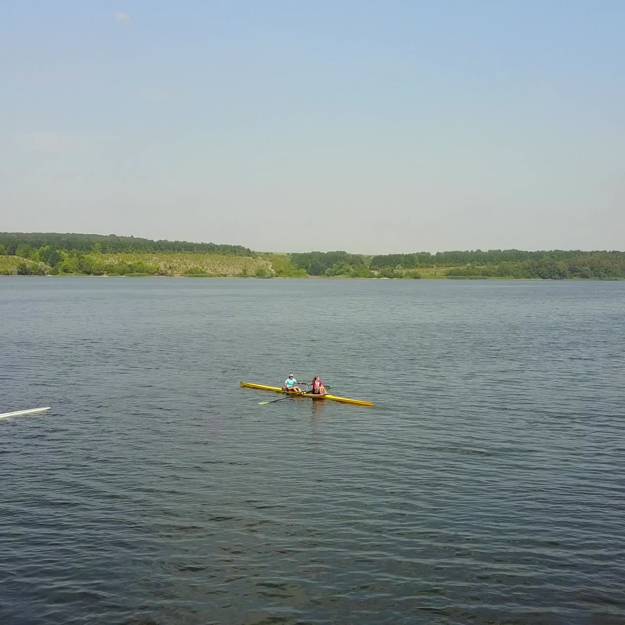 Young Children Kayaking On River. People in boat rowing in kayak over the river