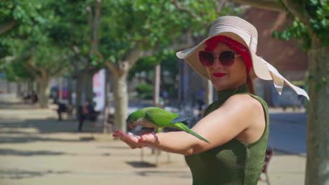 stunning video of parrots eating seeds from the hand of a caucasian girl in green dress with a knitted hat