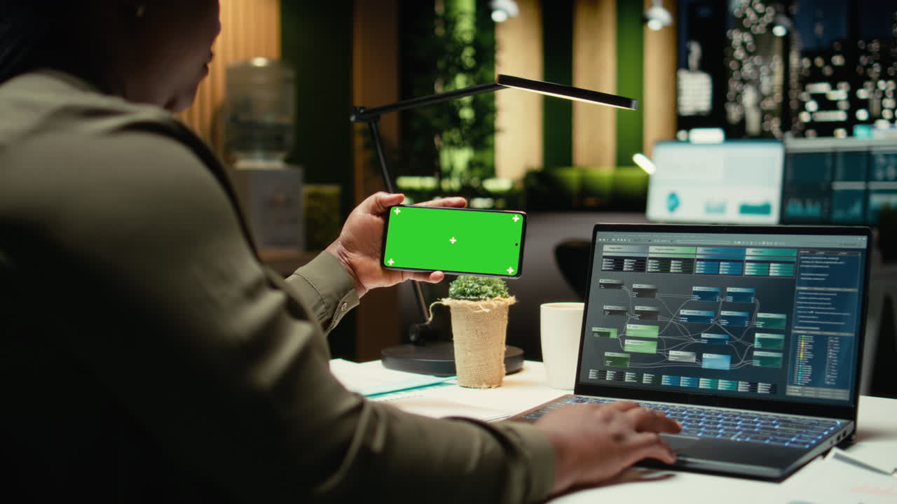 Chroma key on phone held by african american woman checking data reports