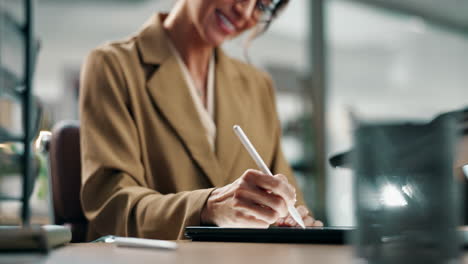 businesswoman using tablet with stylus in office