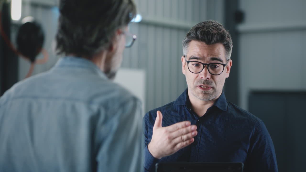 Two Professionals Discussing with a Tablet
