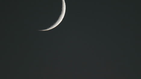 closeup time lapse of waxing crescent moon setting above oak view california