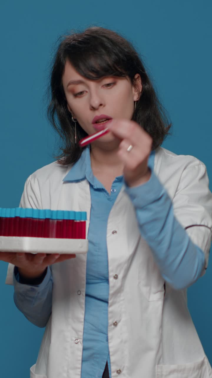 Scientist with blood samples in test tubes
