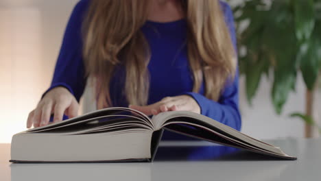 a woman opens a book