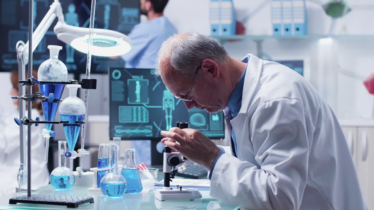 Scientist in laboratory working with a microscope and conducting research