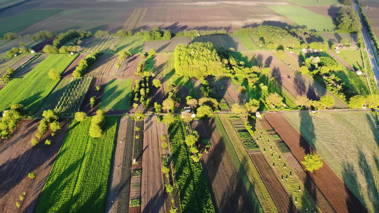 An area lit with light filtering through clouds casting long shadows, drone footage