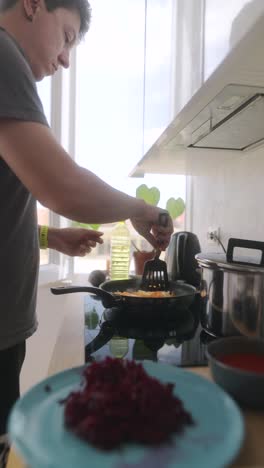 man cooking beets in a kitchen
