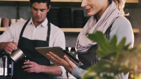 waitress using digital tablet at counter