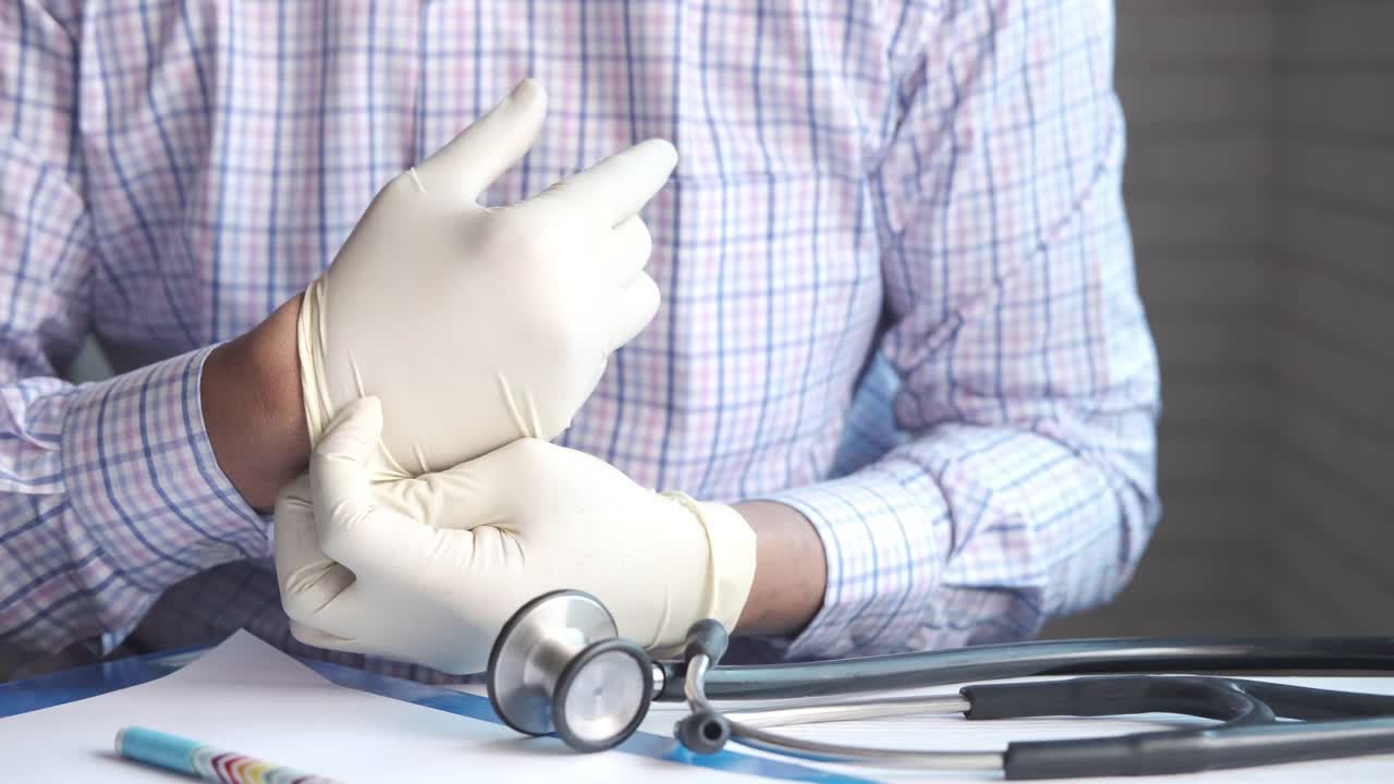 Dokter memakai sarung tangan