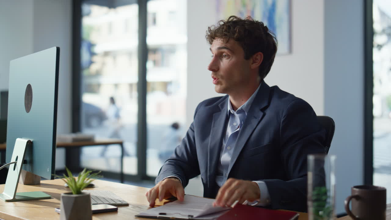 Businessman holding papers talking to webcam laptop online in open space closeup