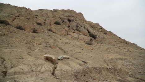 Small-rocky-hills-in-the-Facala,-Ascope-Peru-Landscape-in-the-desert-of-La-Libertad:-Blue-sky-with-white-clouds-over-small-rock-mountain-landscape